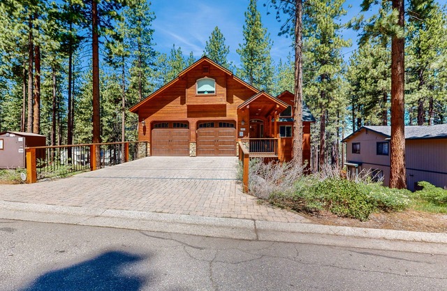 Dog-friendly wooded retreat near skiing, beaches, dining w/2 living rooms & deck