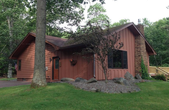 Escape to the Northwoods at this picturesque Sand Lake home
