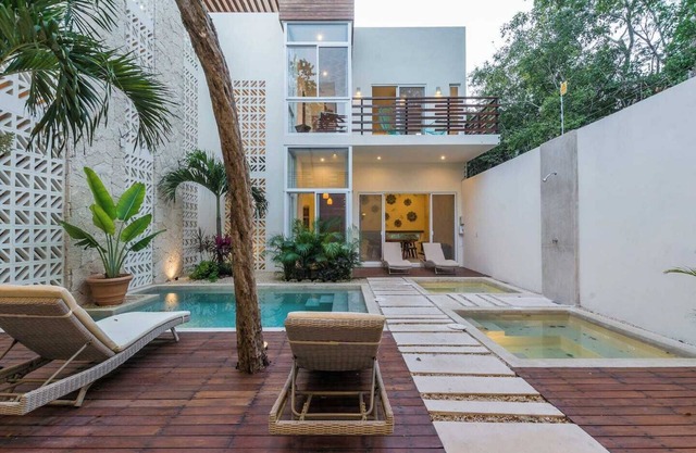 Experience tropical luxury in our villa with pools, lush surroundings, and concierge in Aldea Zama