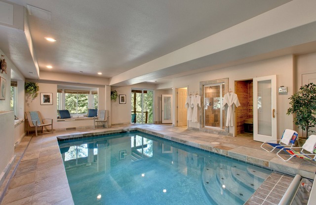 Indoor heated pool, spacious deck, seven rooms with beds, hot tub, and more!