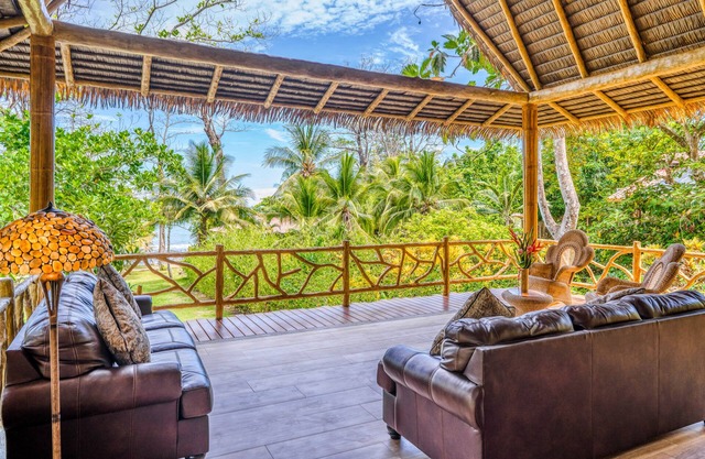 Jungle paradise on beach with open-air living, full kitchen, & shared pool