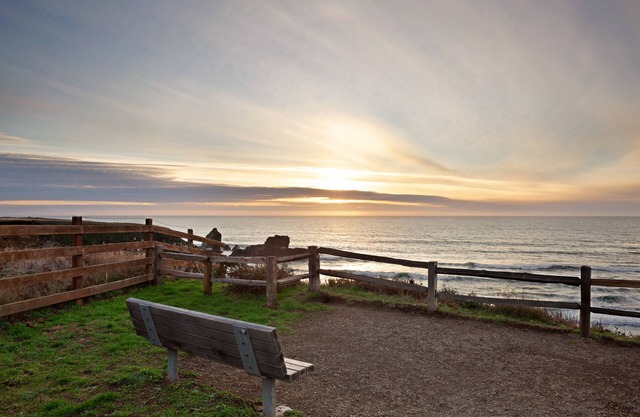 Lower-level cottage with ocean views, fireplace, furnished deck, & internet
