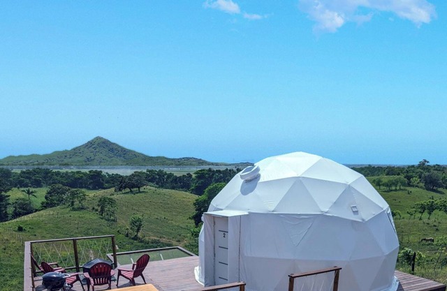 Luxurious Dome set on hillside with views to a lagoon, the ocean and mountains