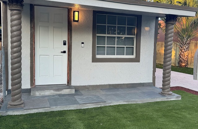 Modern home with driveway parking and fenced yard.