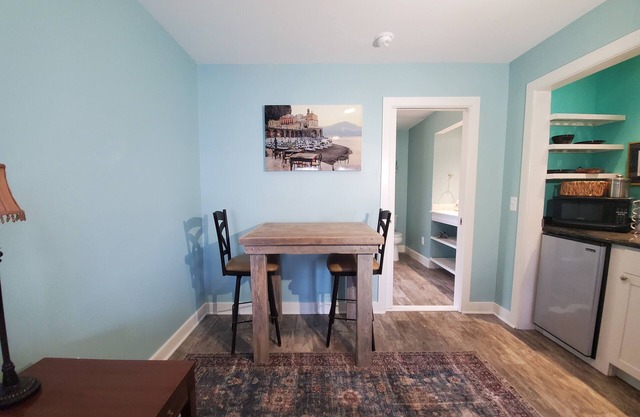 Modern room with walk in shower and kitchenette