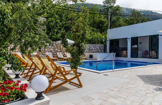 Modern villa with swimming pool overlooking the green hills of Budva