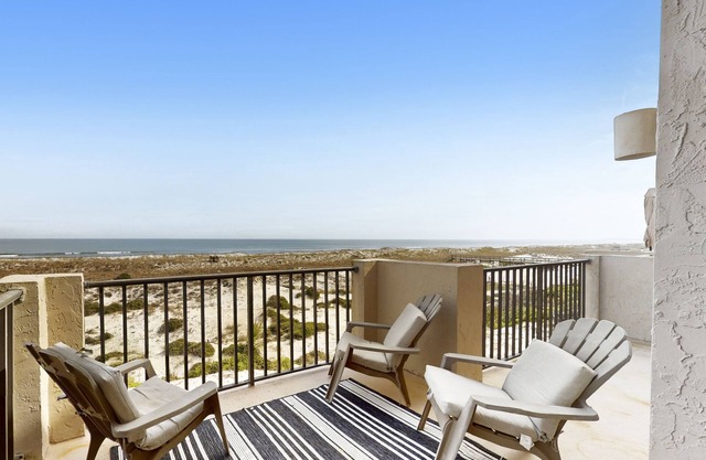 Oceanfront townhome with a furnished balcony, outdoor pool, & tennis