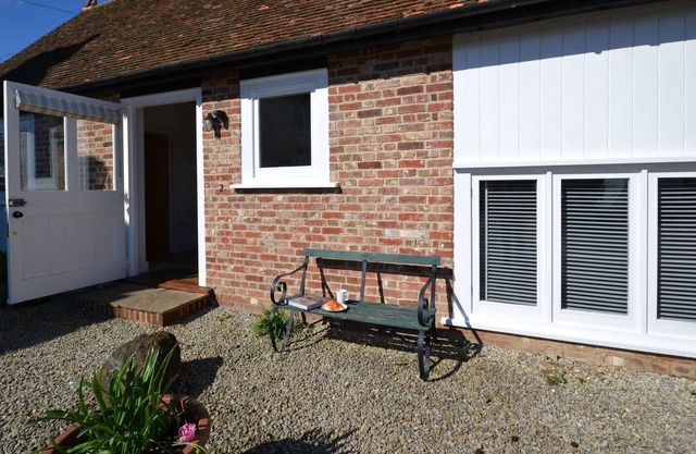 One of a pair of tastefully converted stables sleeping 4, is set over 2 floors with a wealth of beam