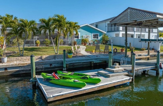 Pirates Den a 4BR Pet-Friendly Waterfront Oasis with Pool, Dock, Personal Water Boats, Fire Pit, Game Room and Bar