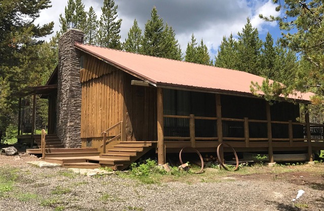 Porch lined cabin nestled in the Pines for lazy summer days