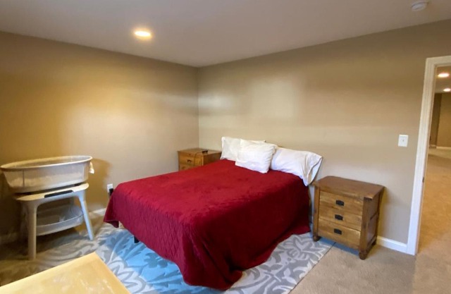 Private basement bedroom with private bathroom, kitchen, and living room with large screen television