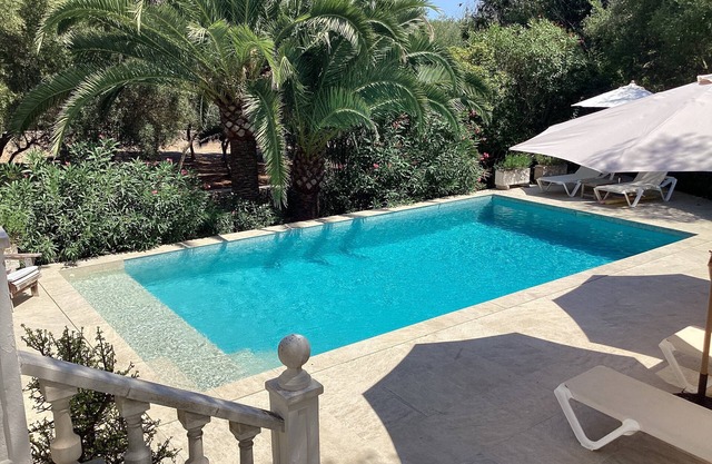Private villa with mature gardens, 2 minutes walk from sandy beach.