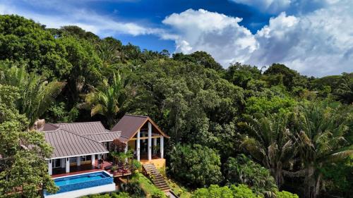 Relax At This Hillside Retreat That Overlooks The Lush Forest And The Caribbean,