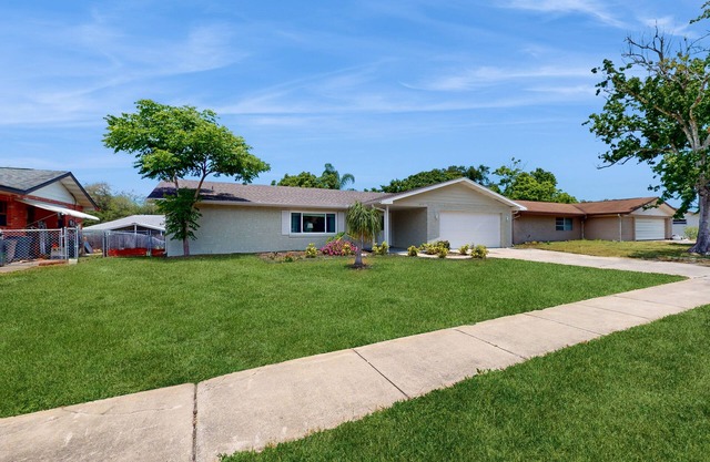 Relaxing, single-level home with a sunroom, large yard, central AC, & fast WiFi