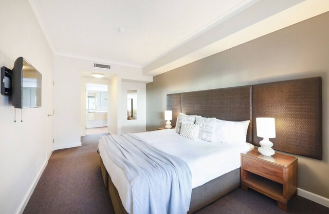 Resort-Inspired Escape: King Bed, Pool, and Balcony