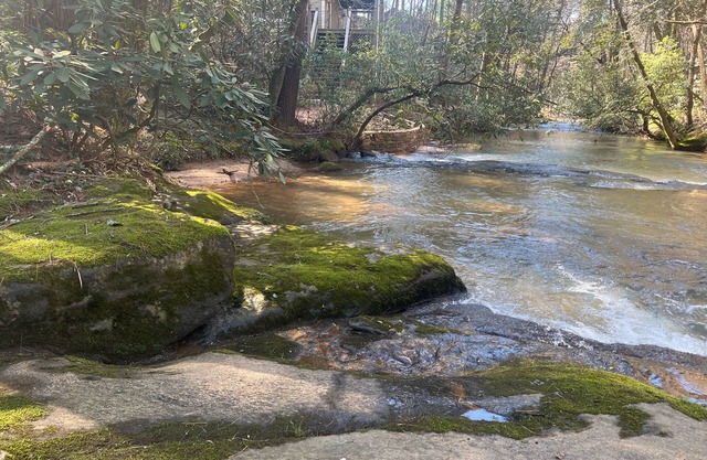 Riverfront hideaway with grill, game room, home theater, screened porch, & deck