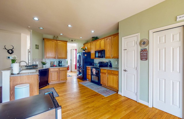 Spacious home with enclosed yard, deck, children's items, full kitchen, & W/D