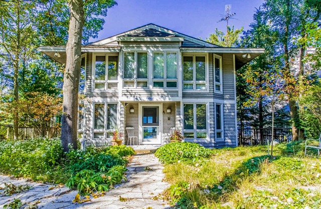 Spacious lakefront home with private beach, hot tub, fire table, & views