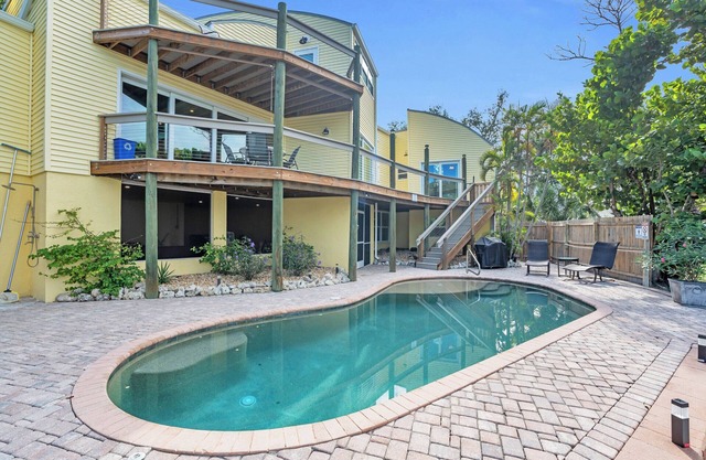 spectacular architectural home steps to the beach w/private heated pool on canal