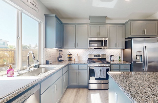 Stunning home with an enclosed yard, pool, jetted tub, board games, W/D, & AC