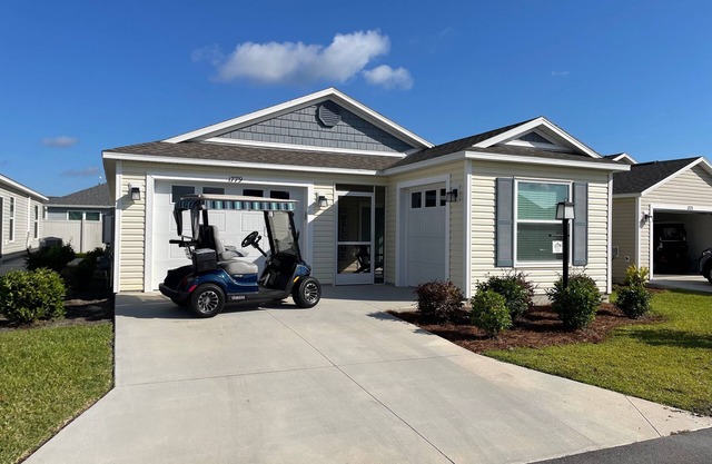 Stylish home with gourmet kitchen, dual garages, and private golf cart!