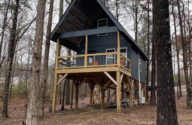 The Treehouses on wooded acreage that overlook a large lake.