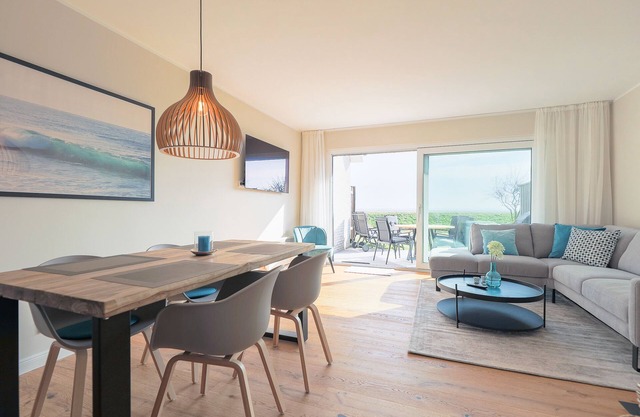 The walls are painted in a warm beige and decorated with cool pictures.