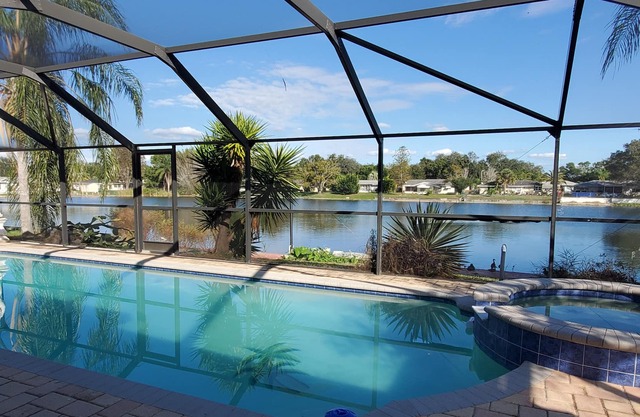 Tropical Waterfront HEATED Pool/SPA Home by 9 BEACHES & 9 STATE PARKS SLEEPS 11