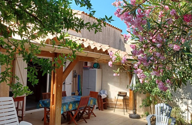 Villa with covered terrace and garden.