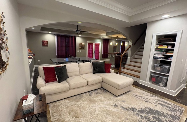 Walkout Basement apartment with a private entrance facing a wooded backyard.