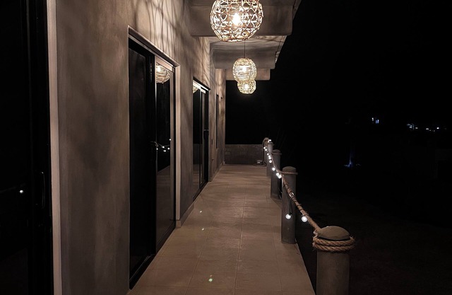 Warm room with the sea in the background and starry skies.