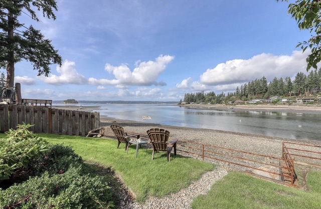 Waterfront home & on-site guest house w/full kitchens, a large deck, & firepits