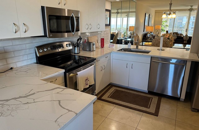 Your paradise awaits! Premier 2+den condo just steps to Vanderbilt Beach