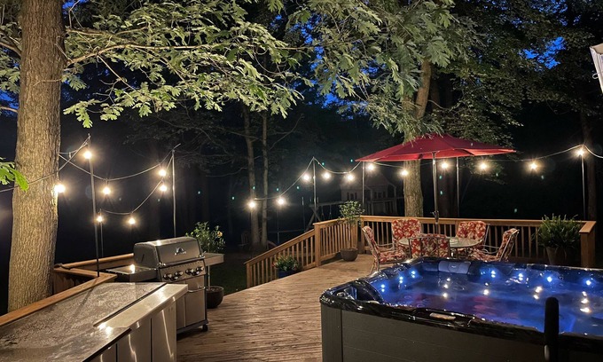 Waupaca House | A beautiful recently remodeled home nested on a wooded river lot with a hot tub.