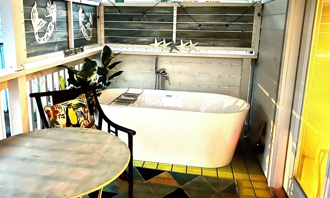 Gulfport House | After beach time come back to an outdoor soaking tub in privacy fenced back yard
