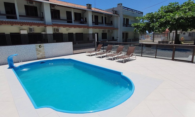 Itapoa Apartment | Apartment in gated community with pool.