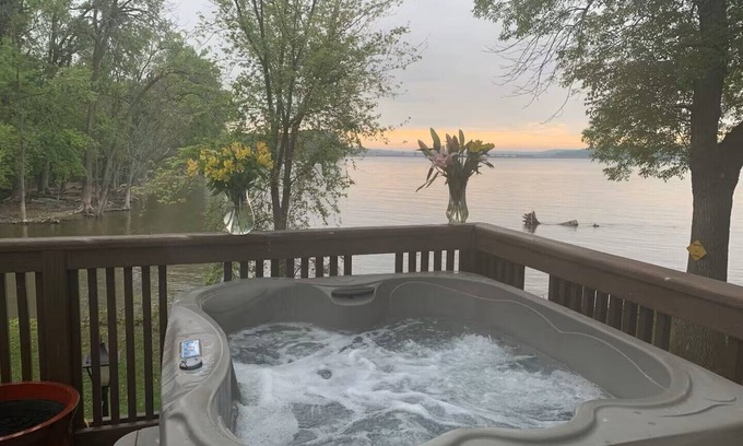 Lynn Center House | Best in QC! AweSpired Riverfront Retreat – Hot Tub, Fireplaces & Stunning Views!