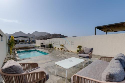 Sharm Apartment | Blue Marble Beach 4BR Villa with Assistants Room, Private Pool, Access to Floating Pier, and Sea and Mountain Views, Al Dana Island, Fujairah by Deluxe Holiday Homes