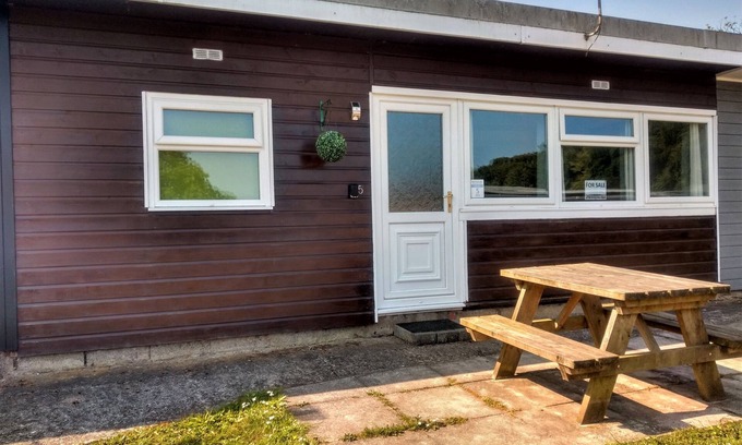 Bucks Cross Ski Chalet | Buck's Cross Bideford Bay Devon chalet has own patio on maintained holiday park.