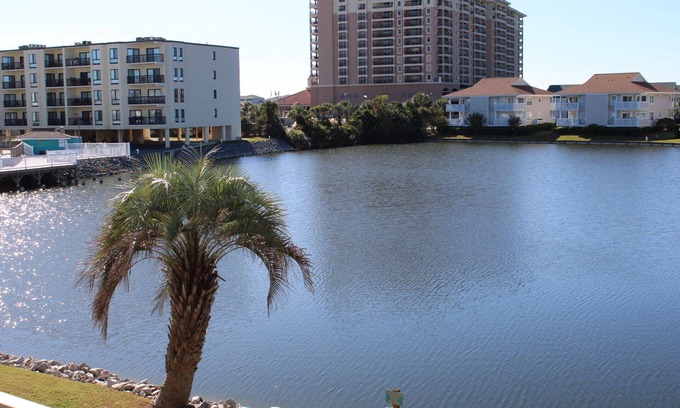 North Myrtle Beach Apartment | Charming 2-bedroom condo offering serene living with picturesque pond vistas, with a lovely pool!