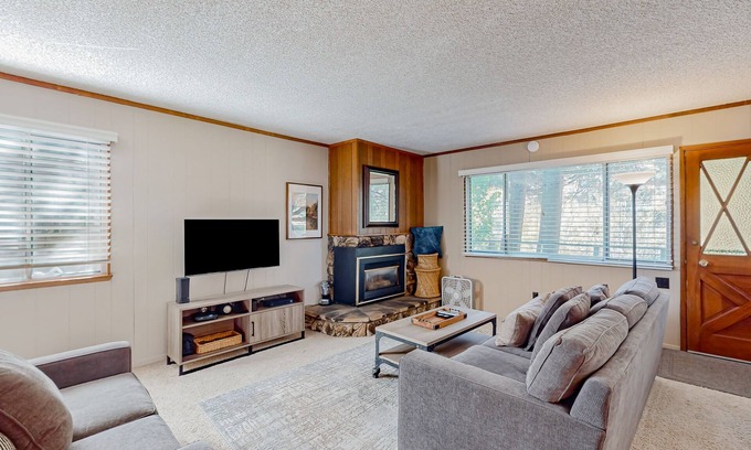 Tahoe Island Cabin | Classic central cabin near river with large tree-lined deck, grassy yard & gym