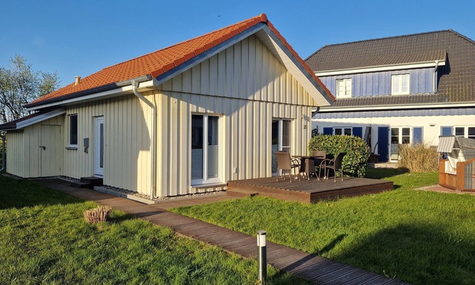 Altefaehr House | Close to the beach holiday home in a quiet field location with a spacious wooden terrace