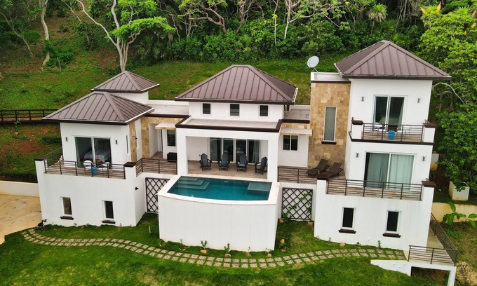 Antoneys Cay Villa | Enchanting blend of sea views and lush green hillside panoramas.