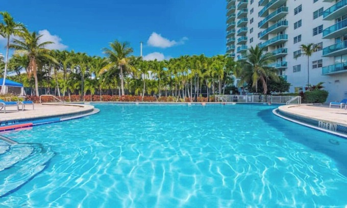 Aventura Condo | Entire condominium with a pool view, steps from the beach