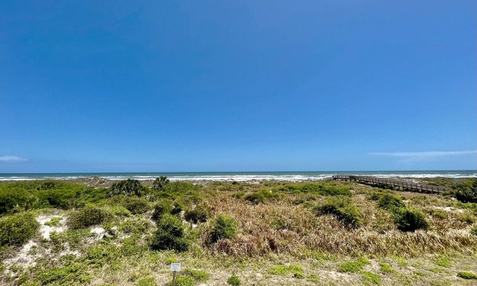 Butler Beach Condo | FREE FUN DAILY with this beautiful corner unit with substantial wrap around porch and marvelous views of the Atlantic Ocean!