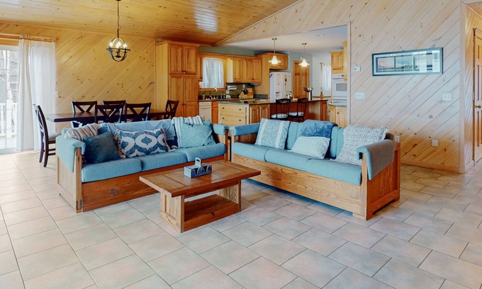 Otis House | Lakefront home with dock, kayak, firepit, screened porch, fireplace, & W/D