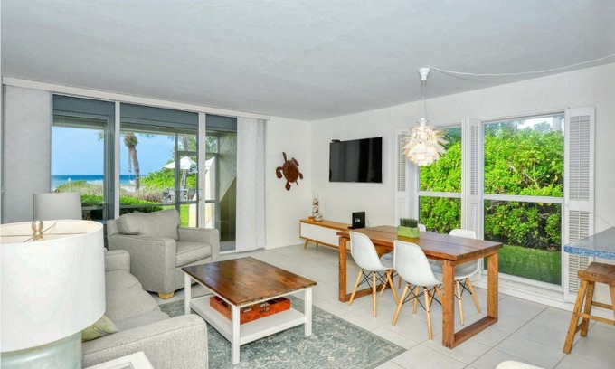 Longboat Key Apartment | LaPlaya 101A Step out to the beach from your screened lanai Light and bright end unit