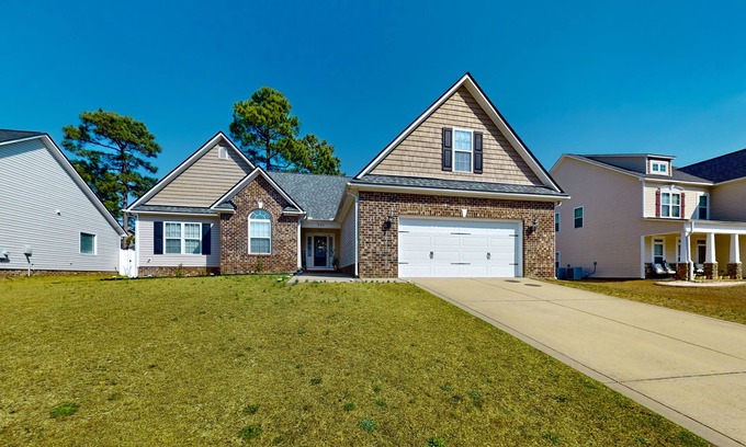 Cameron House | Lovely home with screened-in patio, fireplace, pool, playground, & gym access