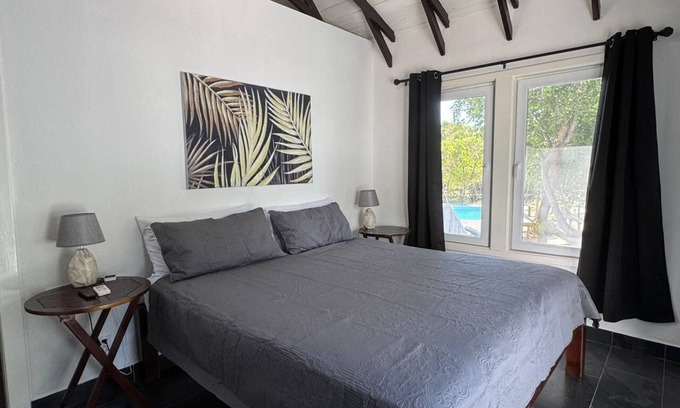 Roatan Cottage | Modern Beachfront Home - Steps from the Sea w/Patio, Shared Pool & Dock