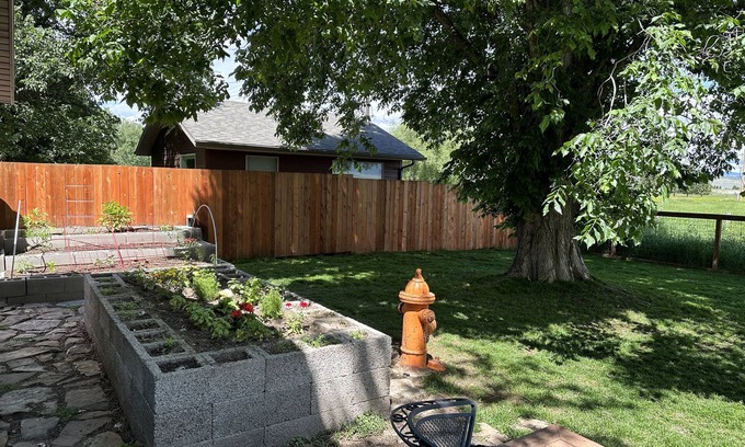 Ennis House | Pet friendly home with fenced yard, gardens and sauna one block from Main Street